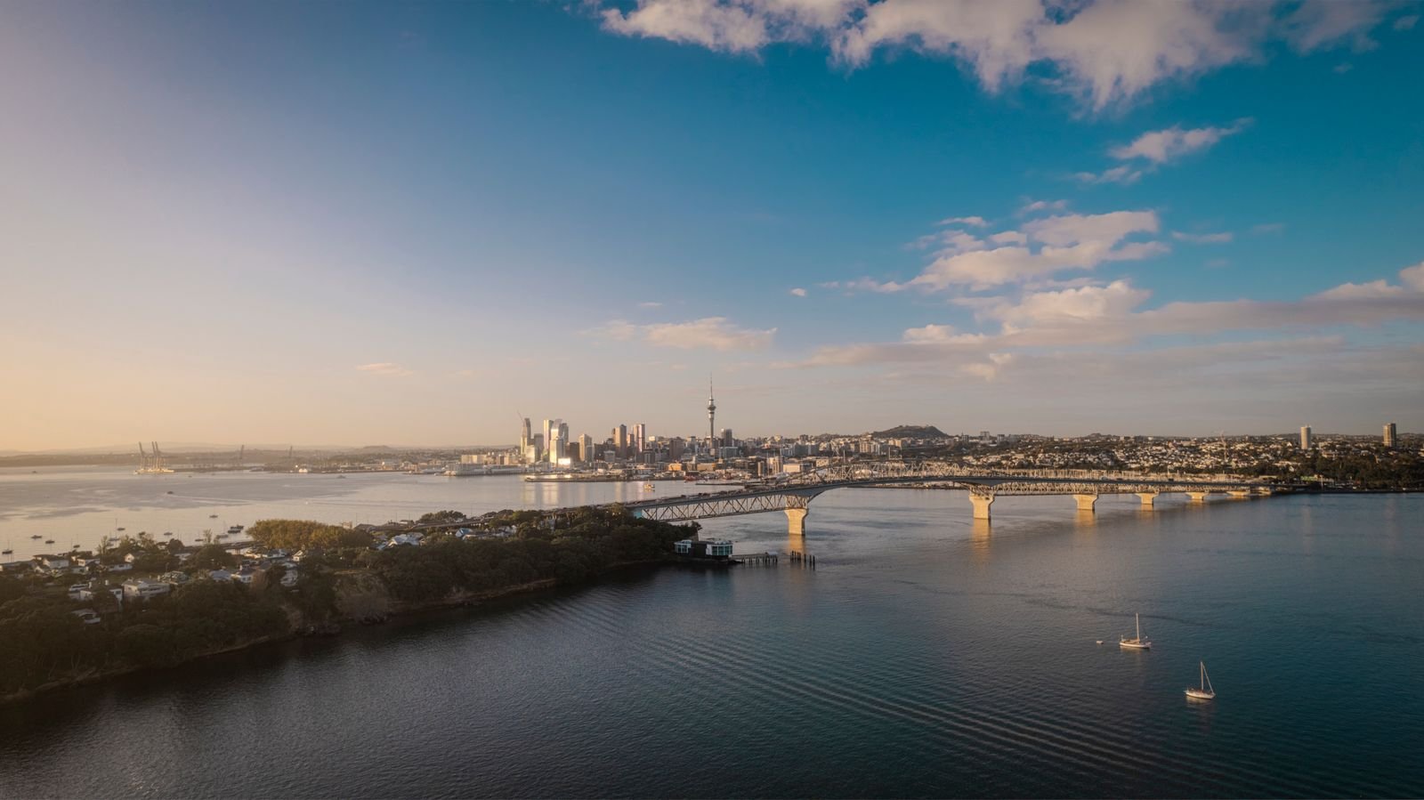 Aerial view of the Auckland skyline and Harbour Bridge at sunset, New Zealand