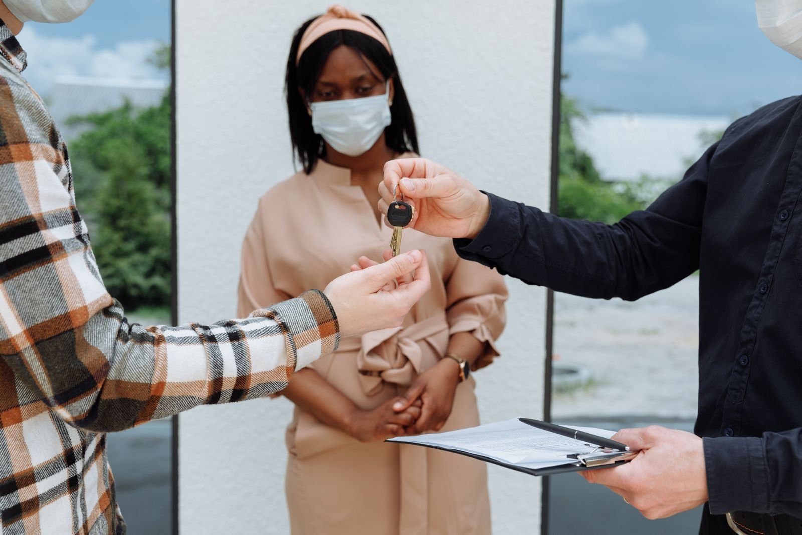 A real estate agent handing house keys to a buyer